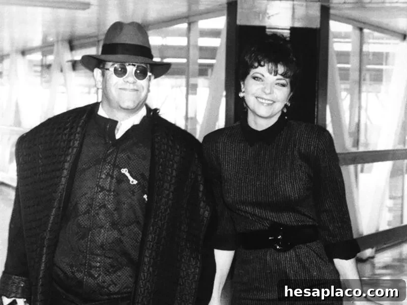 Pop star Elton John and his wife Renate arrive at London's Heathrow Airport in October 1986 from Los Angeles