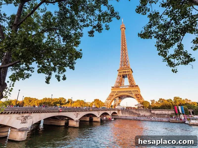 Panoramic view of Eiffel tower and Seine river at sunset.