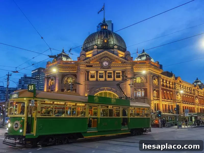 Tram passing Flinders Street Station at dusk