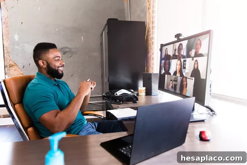 Cheerful businessman video chats with colleagues