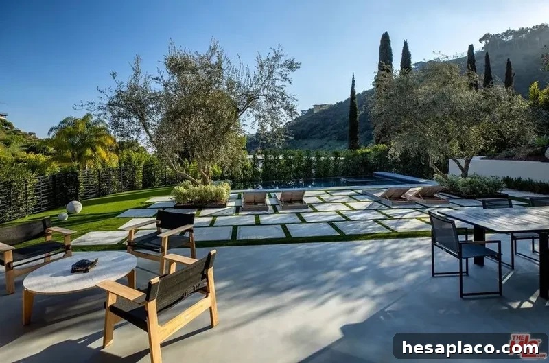 Pool with patio and manicured grounds
