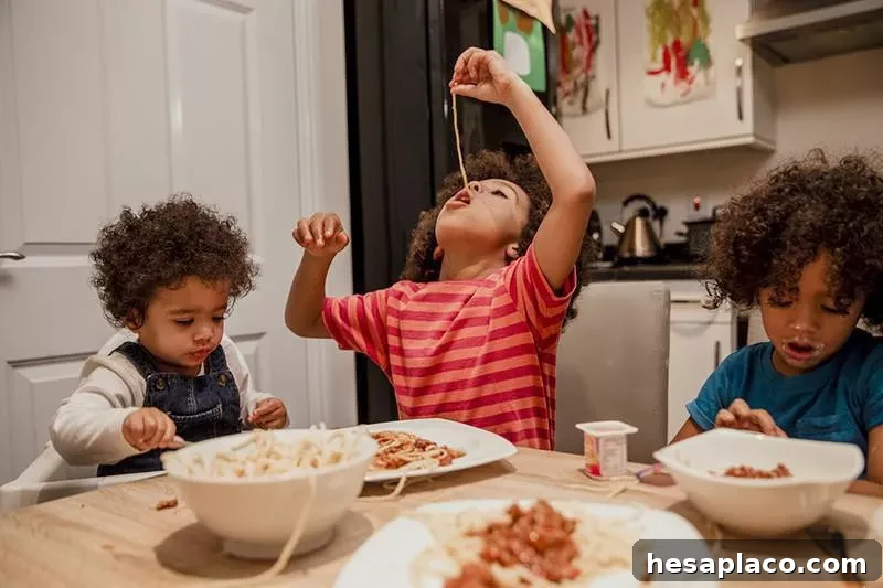Kids eating spaghetti