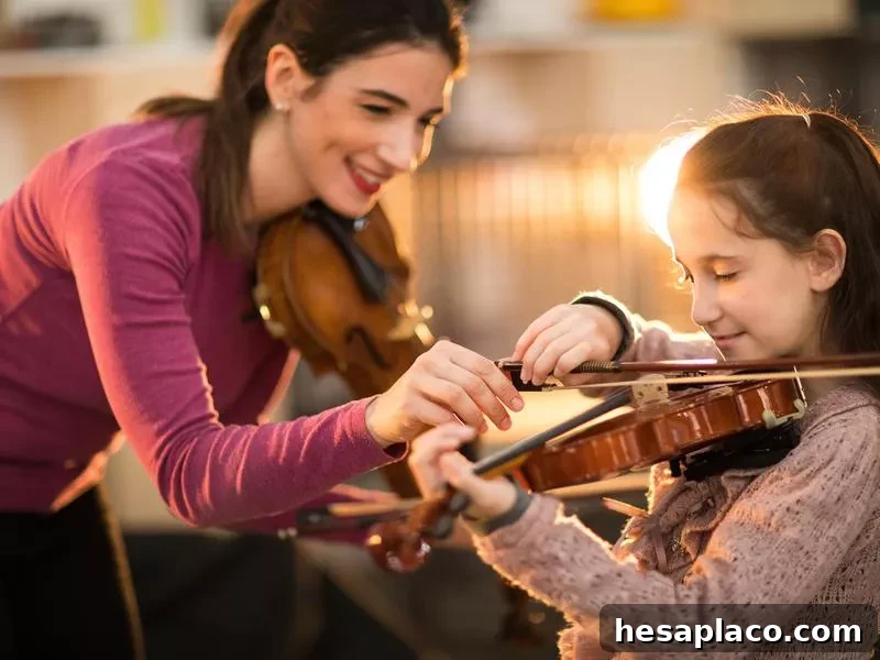 Woman giving violin lesson to kid