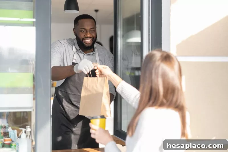 A restaurant worker is serving a guest