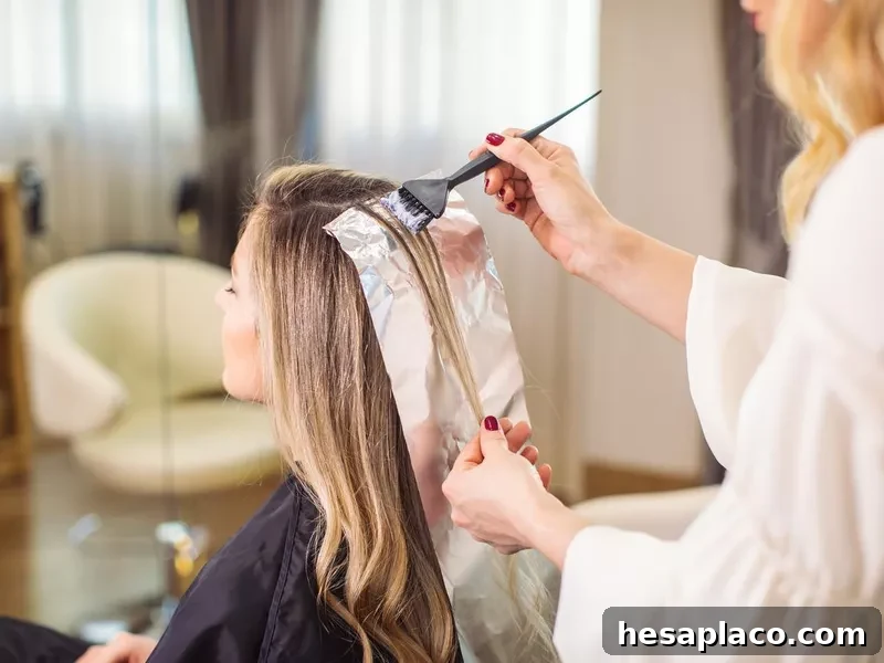 Woman dyeing her hair at the salon