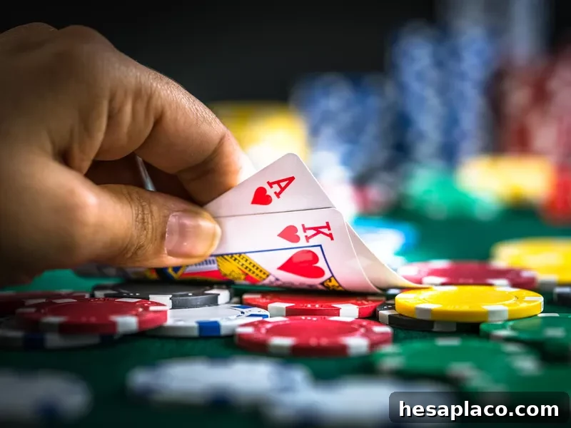 Gambling hand holding poker cards and chips