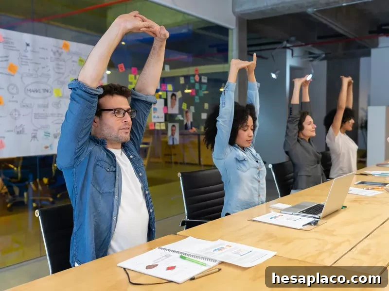 Workers doing stretching exercises in a business meeting