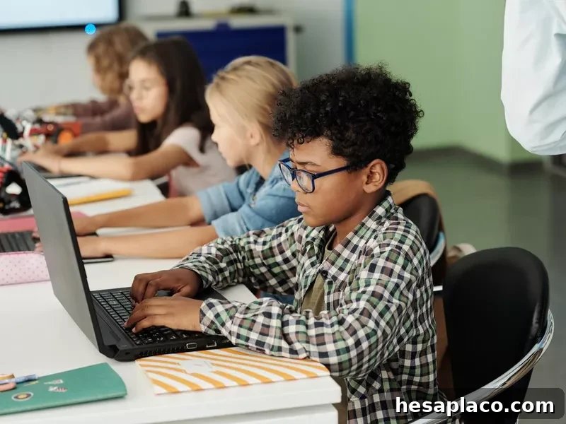 Student working on laptop in class