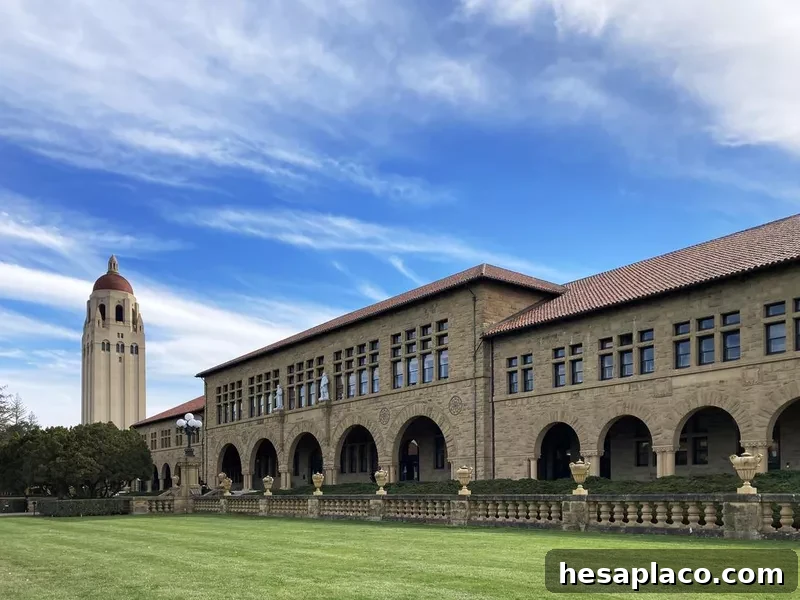 Hoover tower and Lane History Corner building on beautiful campus of Stanford University under blue sky