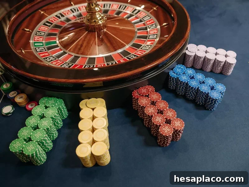 Stacked poker chips beside roulette wheel