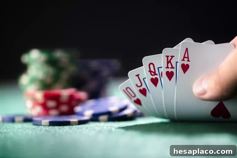 Player playing poker holding a winning royal flush hand of cards