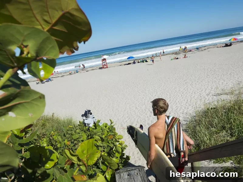 Surfer arriving at the beach