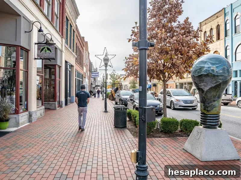People wander Main Street area past Misty Morning sculpture