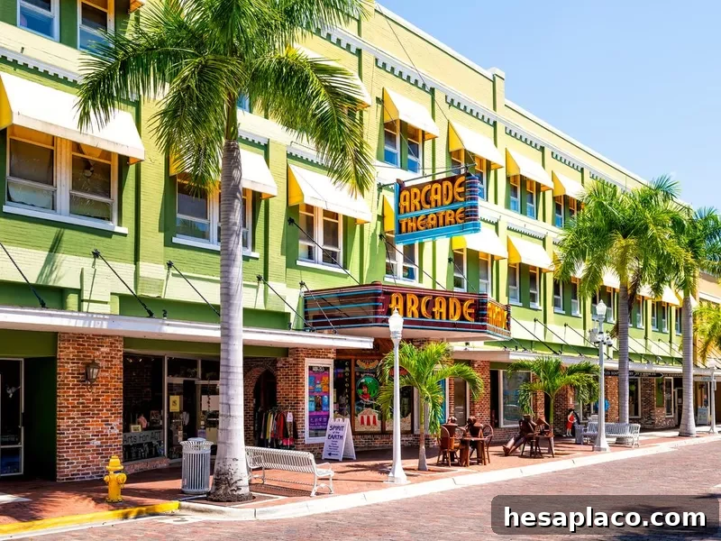 Florida Gulf of Mexico city street with retro vintage neon sign for Arcade theatre theater building with shops stores