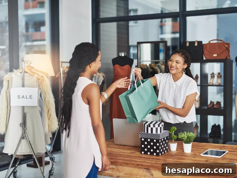 Young store owner handing a bag of paid goods to a customer