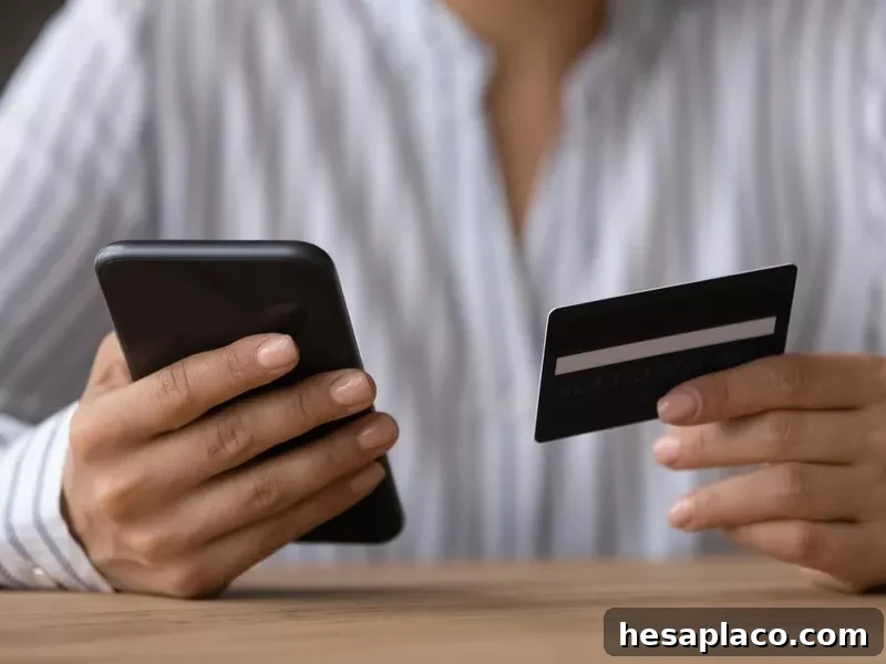Close up woman paying online by credit card, using smartphone