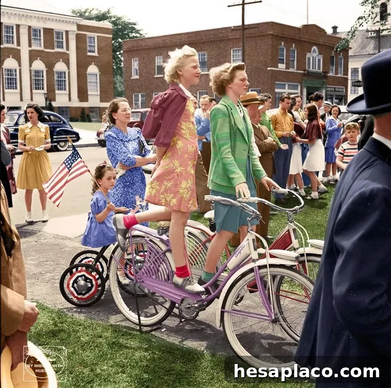 Girls on bikes watching a parade