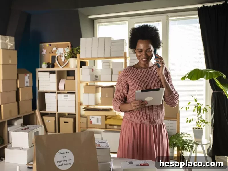Smiling female business owner using digital tablet and talking on the phone