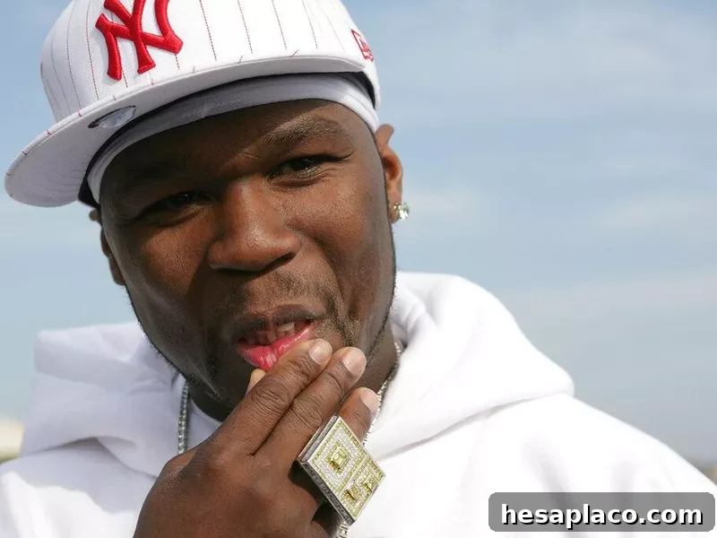 50 Cent rubbing his face with ring