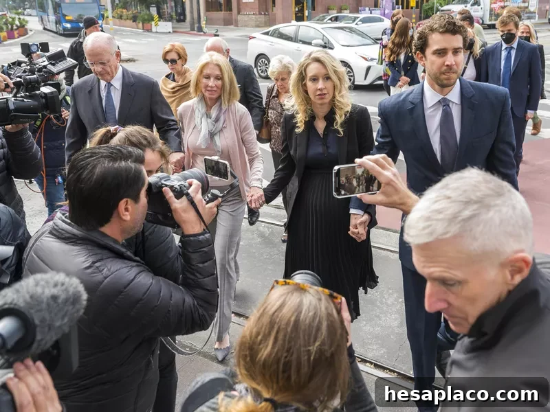 Theranos founder and CEO Elizabeth Holmes, center, her partner Billy Evans, right, and her parents