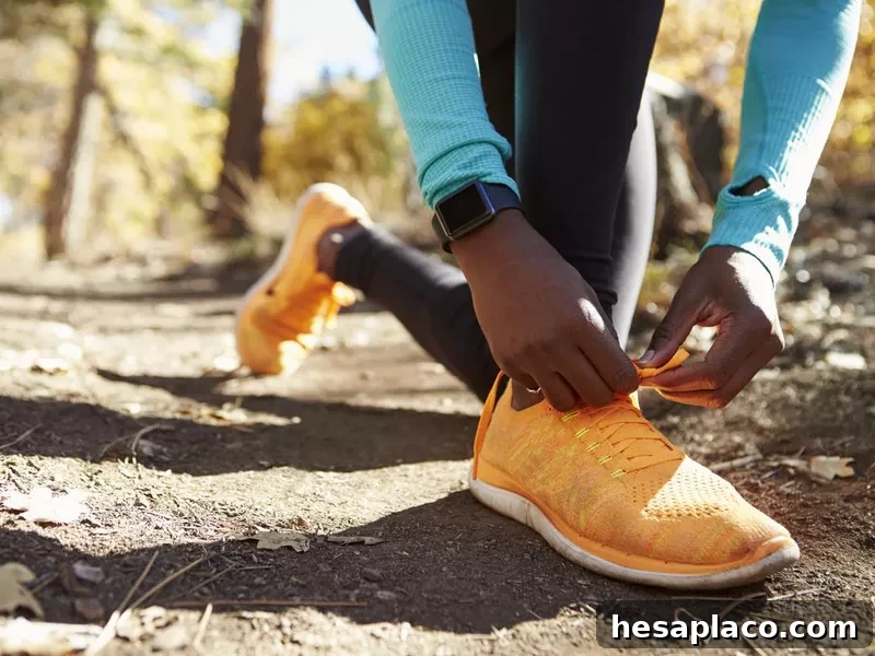Runner in forest tying shoe