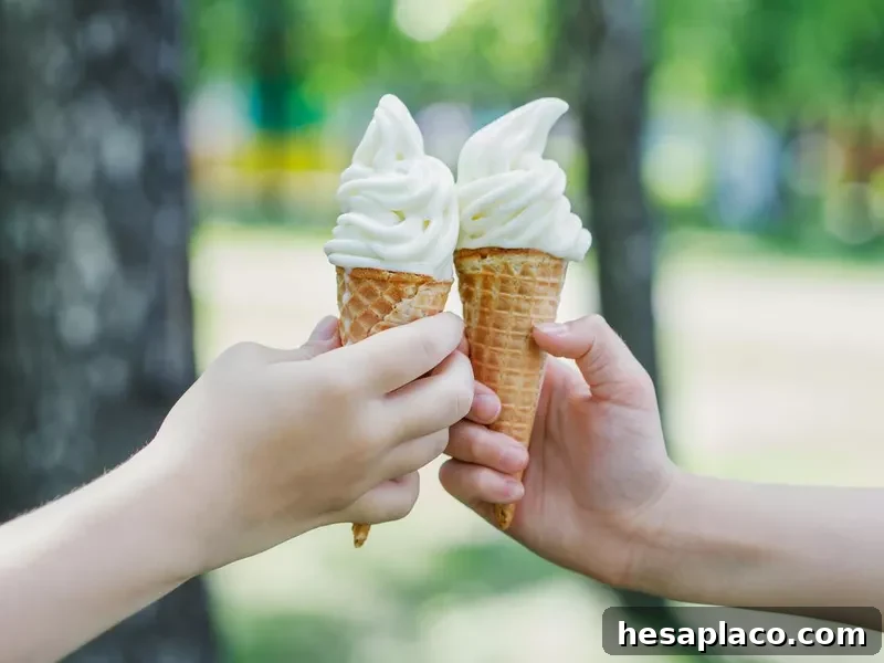 Two cones with ice cream in children's hands