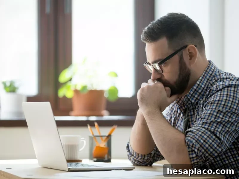 Online moderator looking at laptop