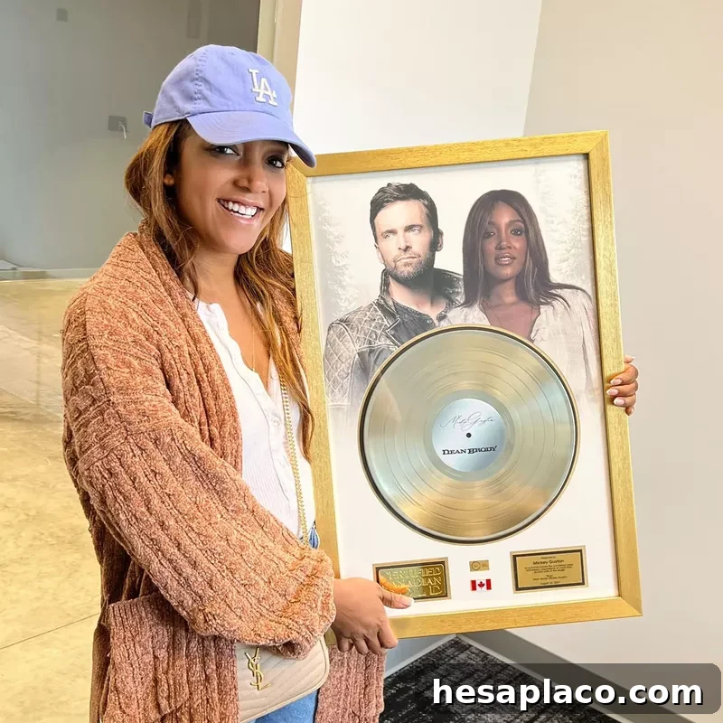 Mickey Guyton and gold record
