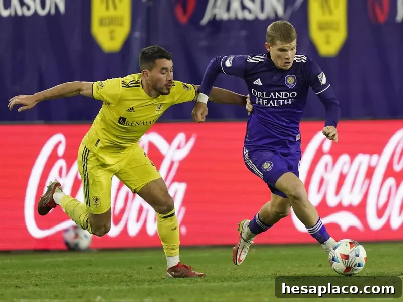 Chris Mueller moves ball ahead of Nashville SC defender Daniel Lovitz