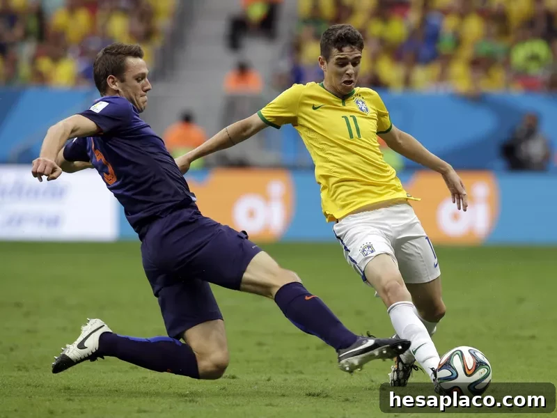 Netherlands' Stefan de Vrij, left, challenges Brazil's Oscar during World Cup third-place soccer match