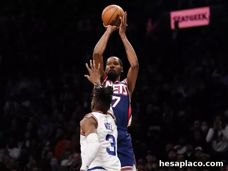 Brooklyn Nets forward Kevin Durant shoots 3-point basket over New York Knicks center Nerlens Noel