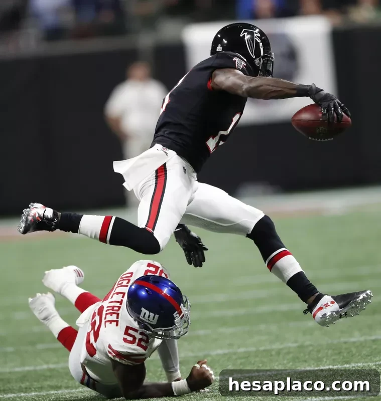Atlanta Falcons wide receiver Julio Jones runs past New York Giants linebacker Alec Ogletree