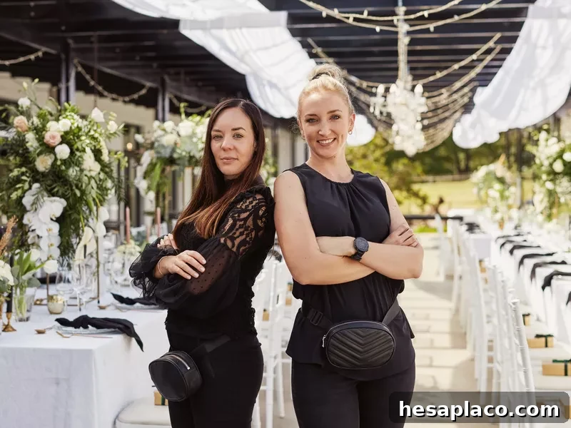 Two event planners standing back to back