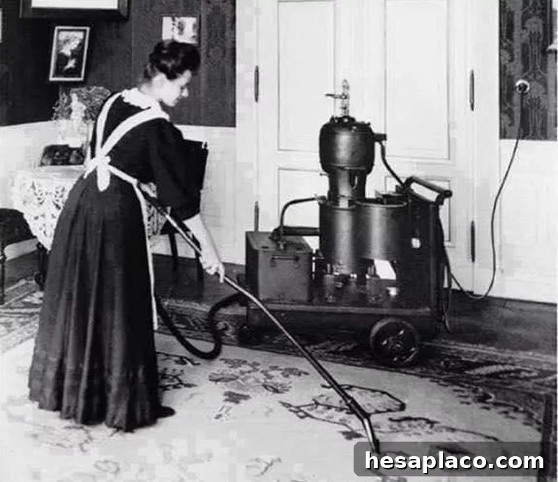 Woman vacuuming in the early 1900s